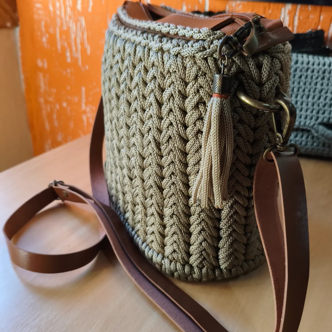 A Bolsa Essência foi criada para mulheres que acreditam que o verdadeiro luxo está na qualidade, no cuidado e na exclusividade do feito à mão.Confeccionada artesanalmente em fio náutico, seu trançado em relevo cria uma textura encantadora que valoriza cada ponto. A tonalidade creme traz leveza e sofisticação, combinando facilmente com diferentes estilos e ocasiões.  Seu acabamento impecável, o fechamento em zíper e a alça regulável unem beleza, praticidade e segurança para acompanhar você em todos os momentos. — foto 5